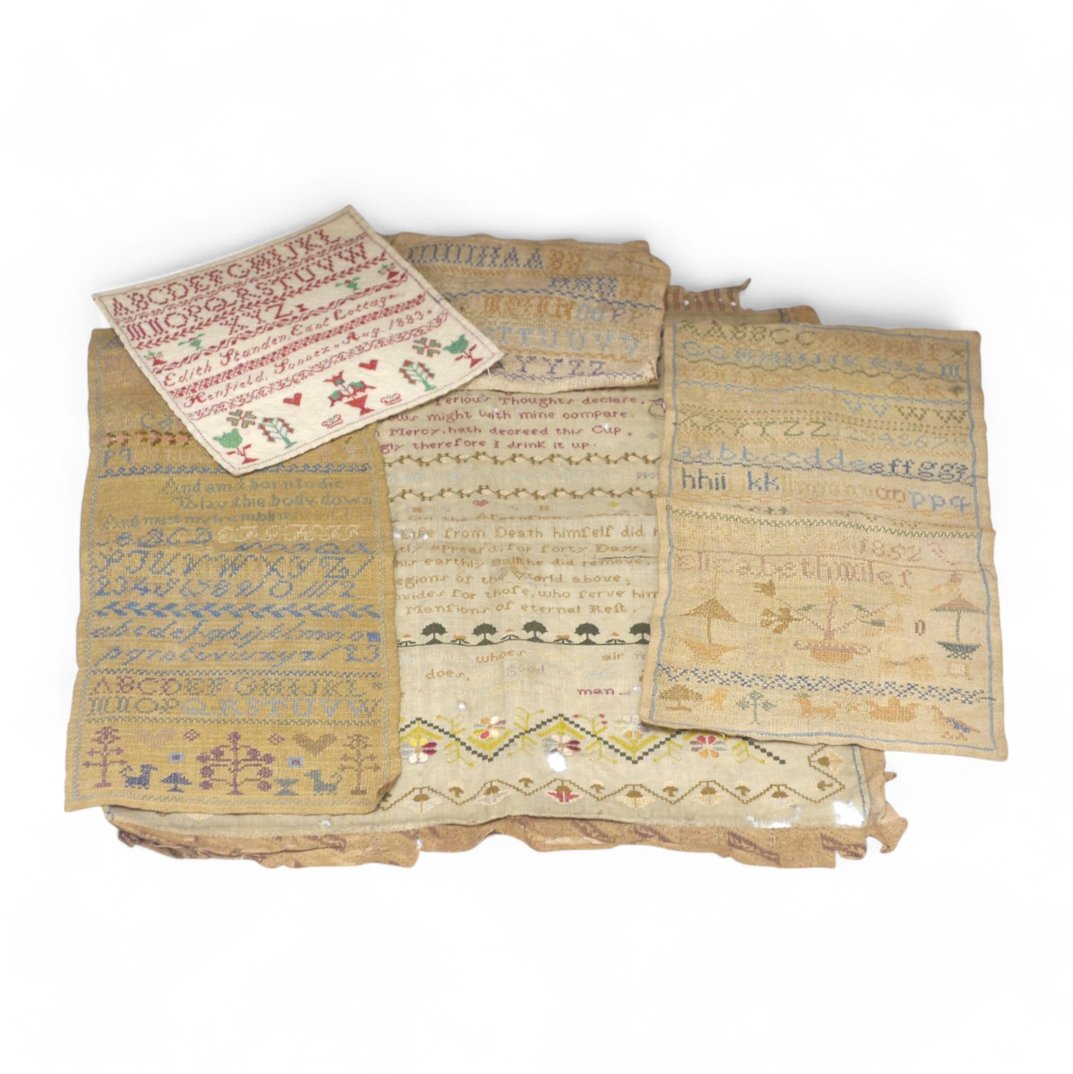 A collection of four 19th century cross stitch alphabet samplers and a larger earlier sampler embroidered by Elizabeth Sizmur aged 11 dated 1795, designed with spot motifs and religious verse. 18th century sampler 42cm x